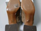 the back view of a pair of women ' s shoes on a white surface