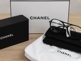 chanel eyeglasses in a black box and a pair of glasses