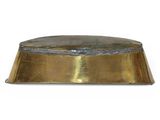 an image of a large brass plate with a domed top