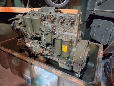 an old military engine sitting in the back of a truck