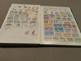 an open book with stamps on it sitting on a table