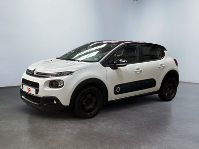 the white citrole is parked in a large room