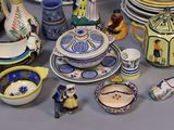 many different types of pottery displayed on the table