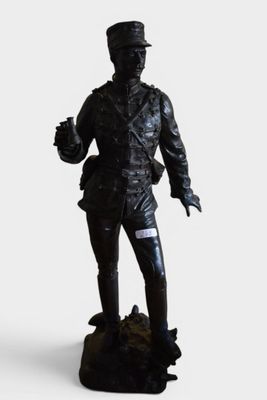 a statue of a man with a hat and a cane