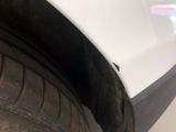 a close up of a tire on a white car