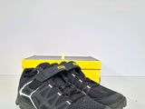a pair of black hiking shoes with a yellow box in the background
