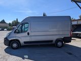 the silver van is parked in a parking lot near a building