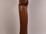 an image of a wooden statue of a woman holding a child