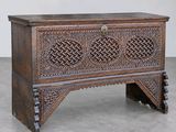 an old wooden chest with intricate carvings on the sides