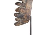 an image of a wooden sculpture of a hand holding a piece of wood