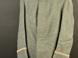 an old coat with a collar and cuffs on a mannequin stand