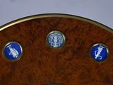 a wooden clock with blue and white stickers on it