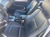 the interior of a car with black leather seats and steering controls