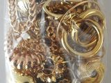 a bag full of gold and silver jewelry on a table