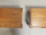 two small wooden tables with a drawer on top of them