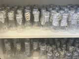 many glasses on the shelves in the store