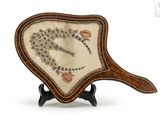 a small fan with a design on it on a stand