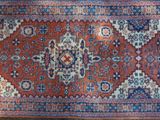 a close up of a rug on a wooden floor in a room