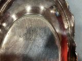 a close up of a silver plate with writing on it