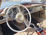 a dashboard and steering wheel of a car with a cell phone in it