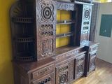 a wooden entertainment center in a room with yellow walls