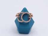 a gold ring with a blue stone and diamonds on it