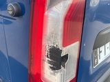 a close up of the tail light of a blue truck