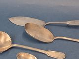 five spoons and two spoons sitting on a table