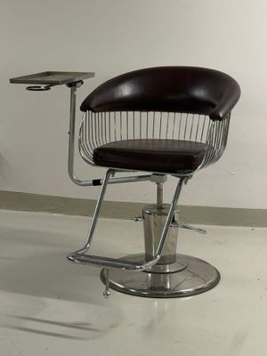 a chair and table in a room with a white wall