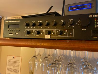 a rack with wine glasses and a radio on it