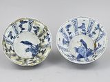 pair of blue and white bowls with birds and flowers on them