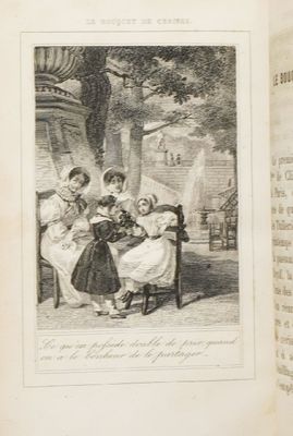 un vieux livre sur lequel figure la photo d'une famille assise sur un banc