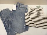 two pairs of jeans and a stripped shirt on a table