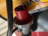 a close up of a gas pump with a red plug