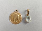 a close up of a small gold medal and a small pendant