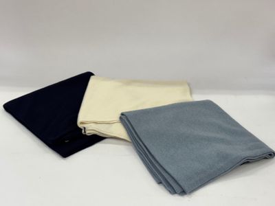 three different colors of cloth folded on top of each other