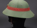 a close up of a green hat on a mannequin head