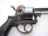 a gun that is sitting on a white surface