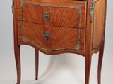 a small chest of drawers with a marble top