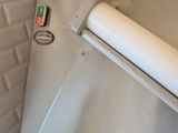 a white refrigerator with a roll of paper on top of it