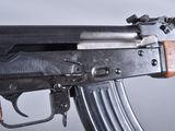 an ak - 74 machine gun with a wooden handle and a metal barrel