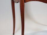 a small wooden table with a drawer on top of it