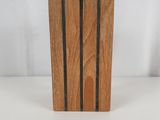 a picture of a wooden block with a black stripe on it