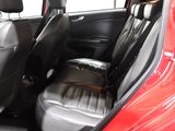 a red car with black leather seats in the back of it