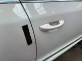 a close up of a car door handle with a sticker on it