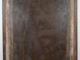 an old wooden frame with a black and white painting on it