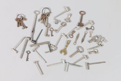 a lot of keys that are laying on a white surface
