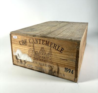 an old wooden box with a label on it sitting on a table