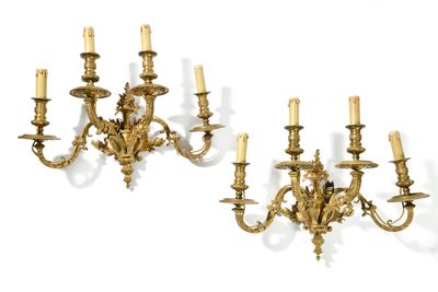 pair of antique brass wall sconces with candles on each side