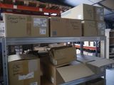 boxes are stacked on a shelf in a warehouse with shelves full of boxes
